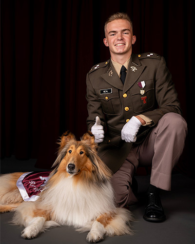 Reveille sitting next to her handler Theodor Neal